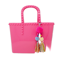 Load image into Gallery viewer, A hot pink jumbo jelly tote bag with a tassel charm attached to it, featuring studs on the handle and top.