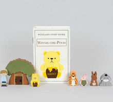 Load image into Gallery viewer, Wooden toys inspired by 'Winnie the Pooh' with a book titled 'Winnie the Pooh' on a light gray background.