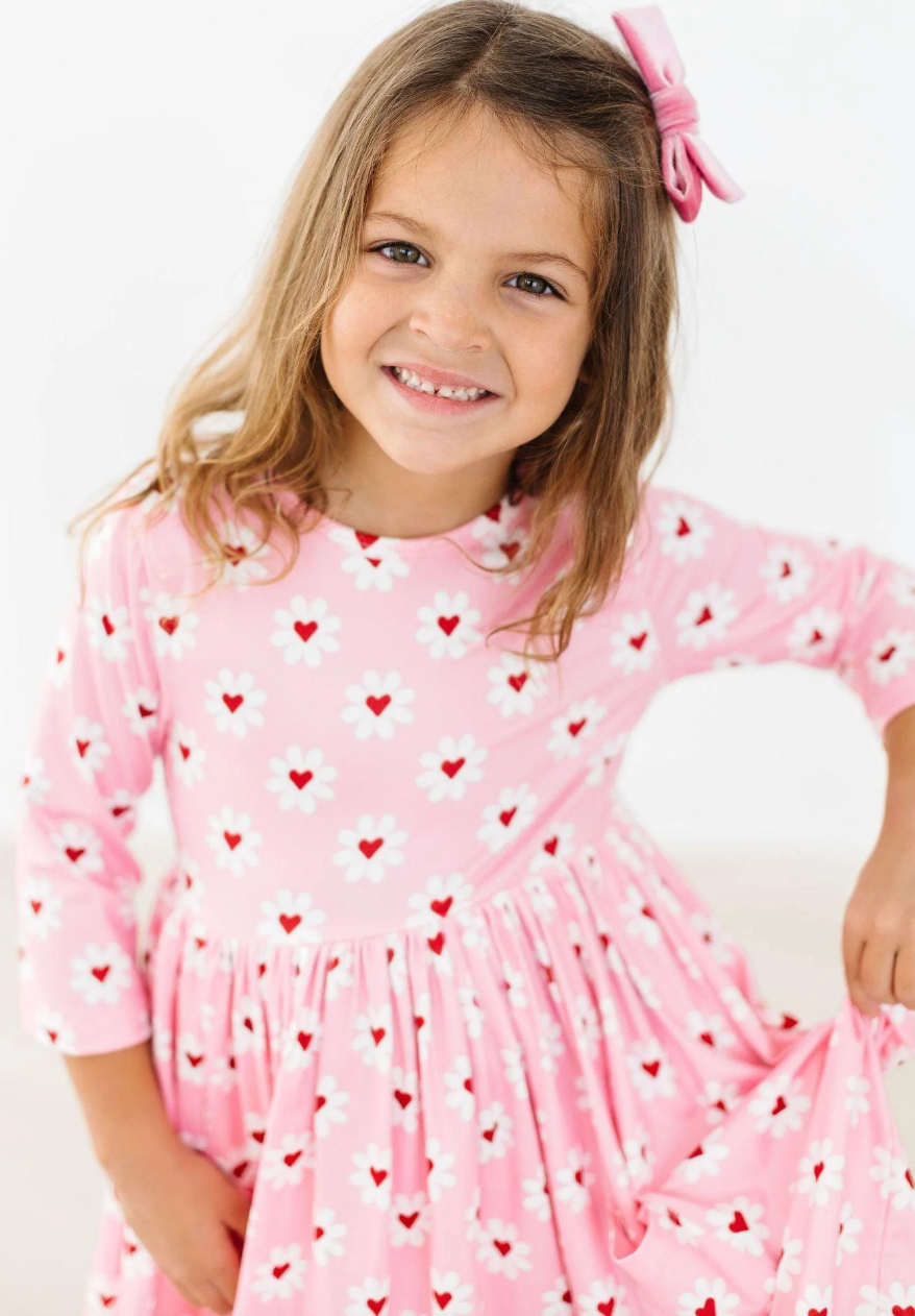 Daisy Delight girls' pocket twirl dress by Mila and Rose featuring a pink and white floral design, perfect for Valentine’s Day.