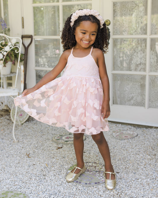 Girls' Pippa Dress by Noralee featuring butterfly print in cotton candy pink, displayed on a girl in a lifestyle setting.