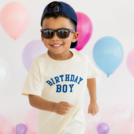 Sweet Wink birthday boy varsity short sleeve T-shirt with bold lettering and colorful design, perfect for celebrating a special day.