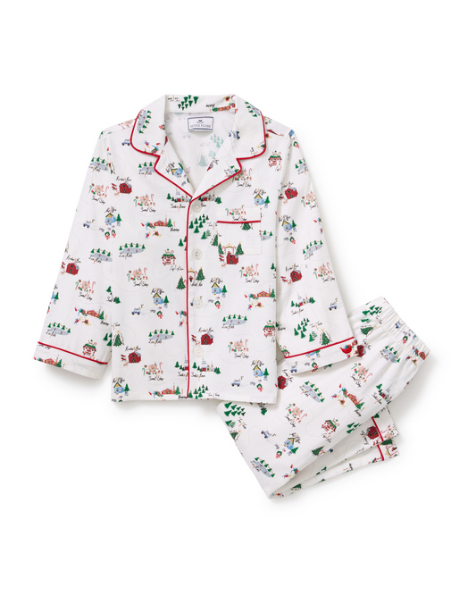 Kids' twill pajama set featuring North Pole Chronicles design by Petite Plume, shown flat with festive holiday pattern.