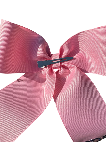 Large personalized embroidered bow with alligator clip by Flora Ottimer, featuring colorful floral embroidery and secure clip attachment.