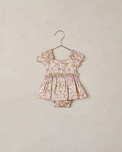 Baby girl Noralee Margot Romper in Wildflower print, featuring soft fabric and floral design, suitable for warm weather.