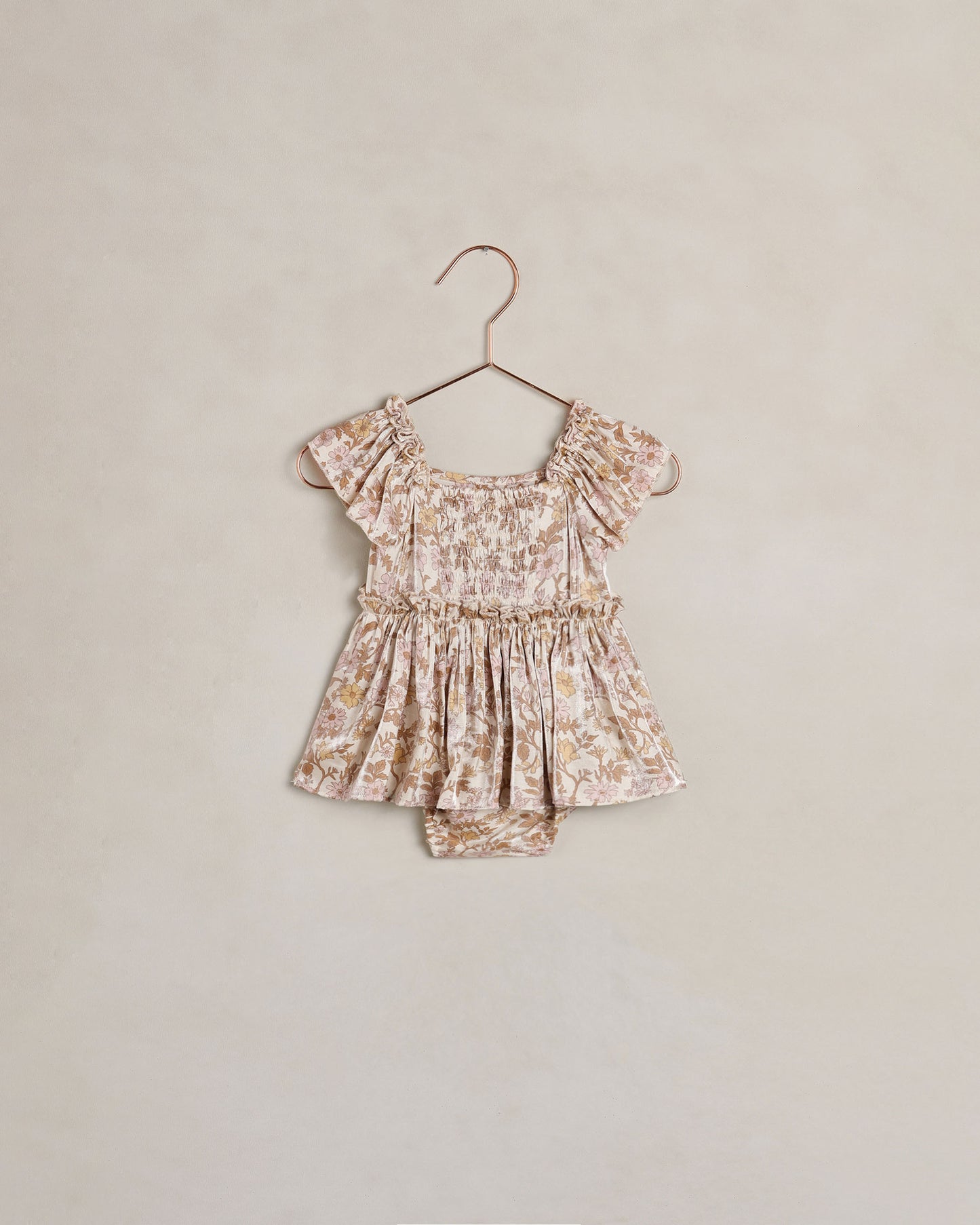 Baby girl Noralee Margot romper in wildflower print, featuring soft fabric and delicate floral design on a natural background.