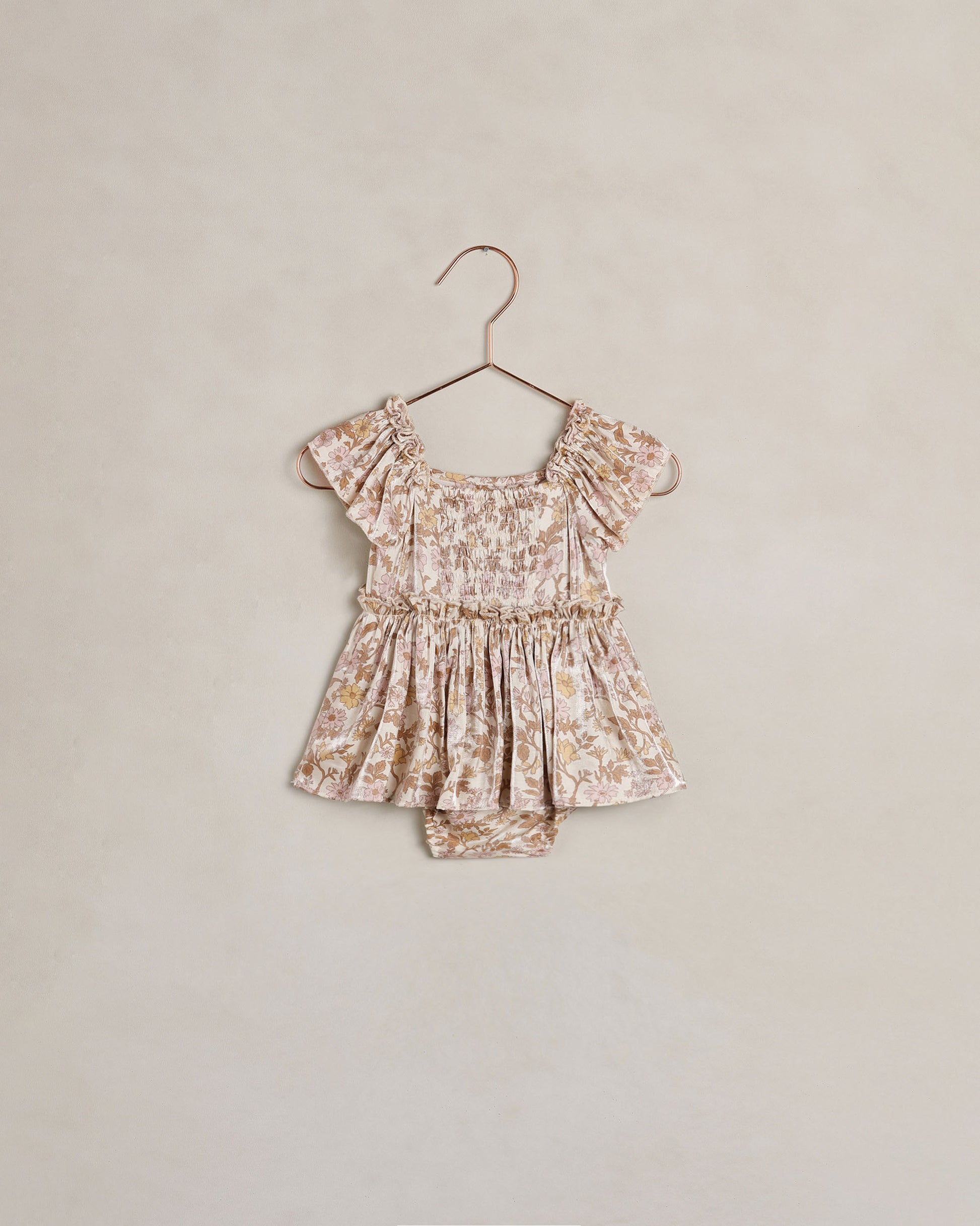 Baby girl Noralee Margot romper in wildflower print, featuring soft fabric and delicate floral design on a natural background.