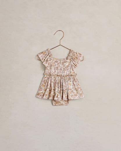 Baby girl Noralee Margot romper in wildflower print, featuring soft fabric and delicate floral design on a natural background.