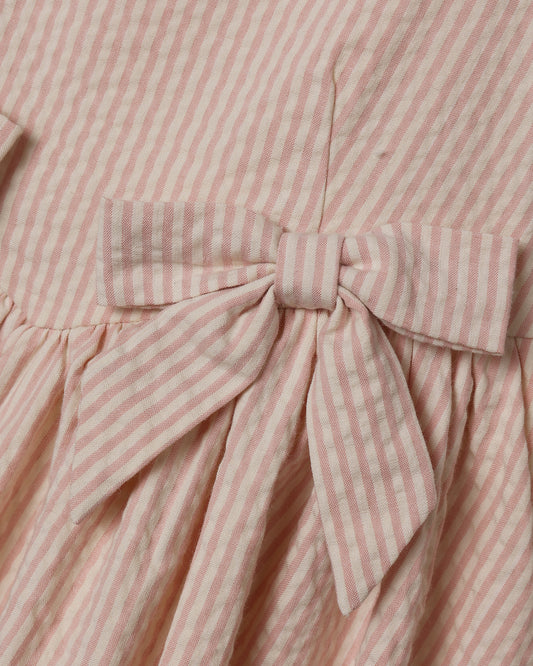 Girls Beatrice Midi Dress in Petal Pink by Noralee, showing a soft pink dress with floral details on a young girl model.