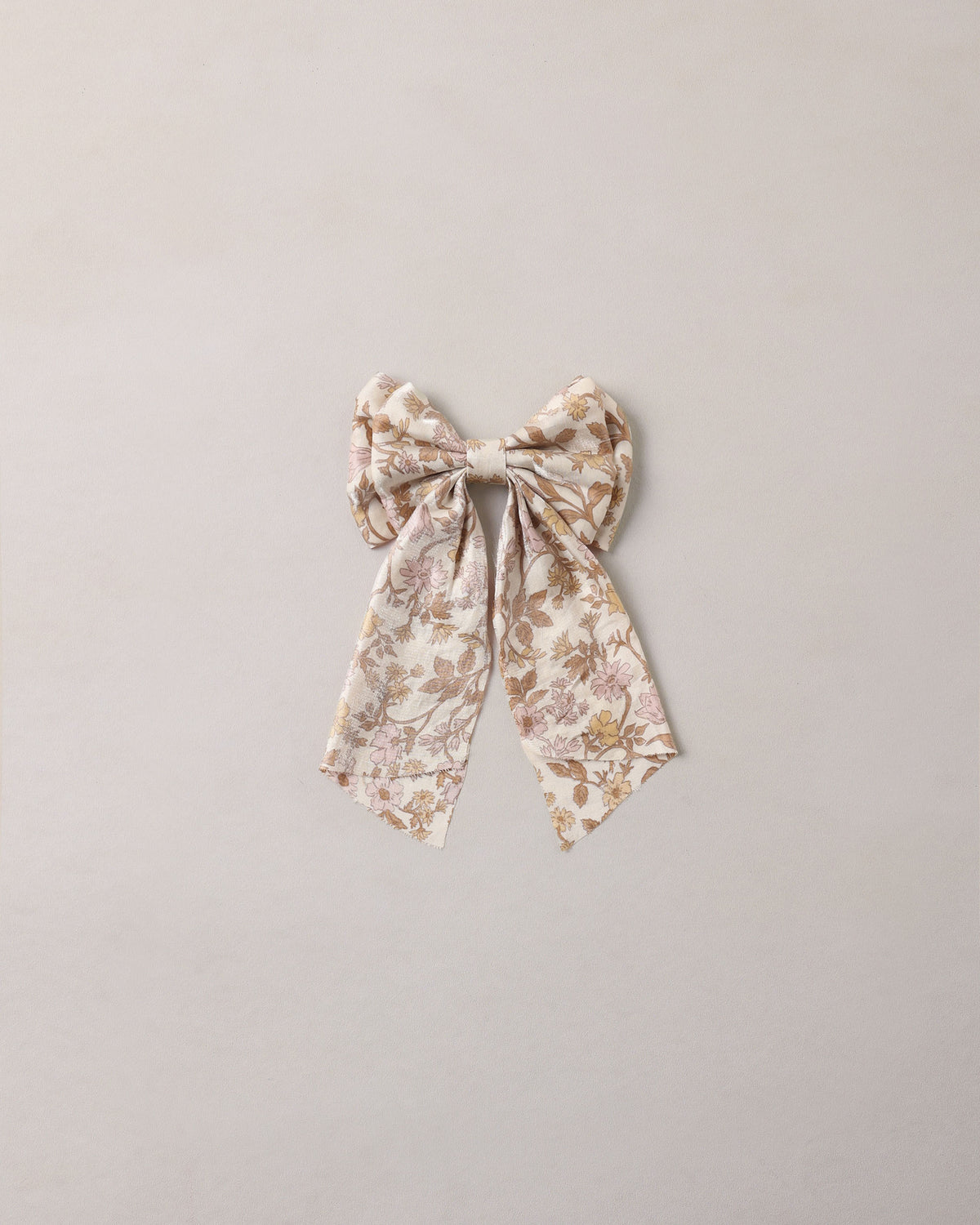Noralee Alice Bow in Wildflower, natural fabric headband with a large floral bow design, styled for a charming, casual look.