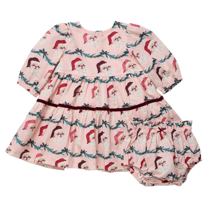 Baby girl wearing Pink Chicken Maribelle dress with Santa garland print, festive holiday attire for infants.