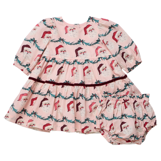 Baby girl wearing Pink Chicken Maribelle dress with Santa garland print, festive holiday attire for infants.