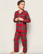 Load image into Gallery viewer, Child wearing red plaid pajamas on a white background
