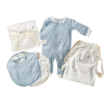 Load image into Gallery viewer, Collection of baby clothing items including a romper, bib, and burp cloth on a beige background
