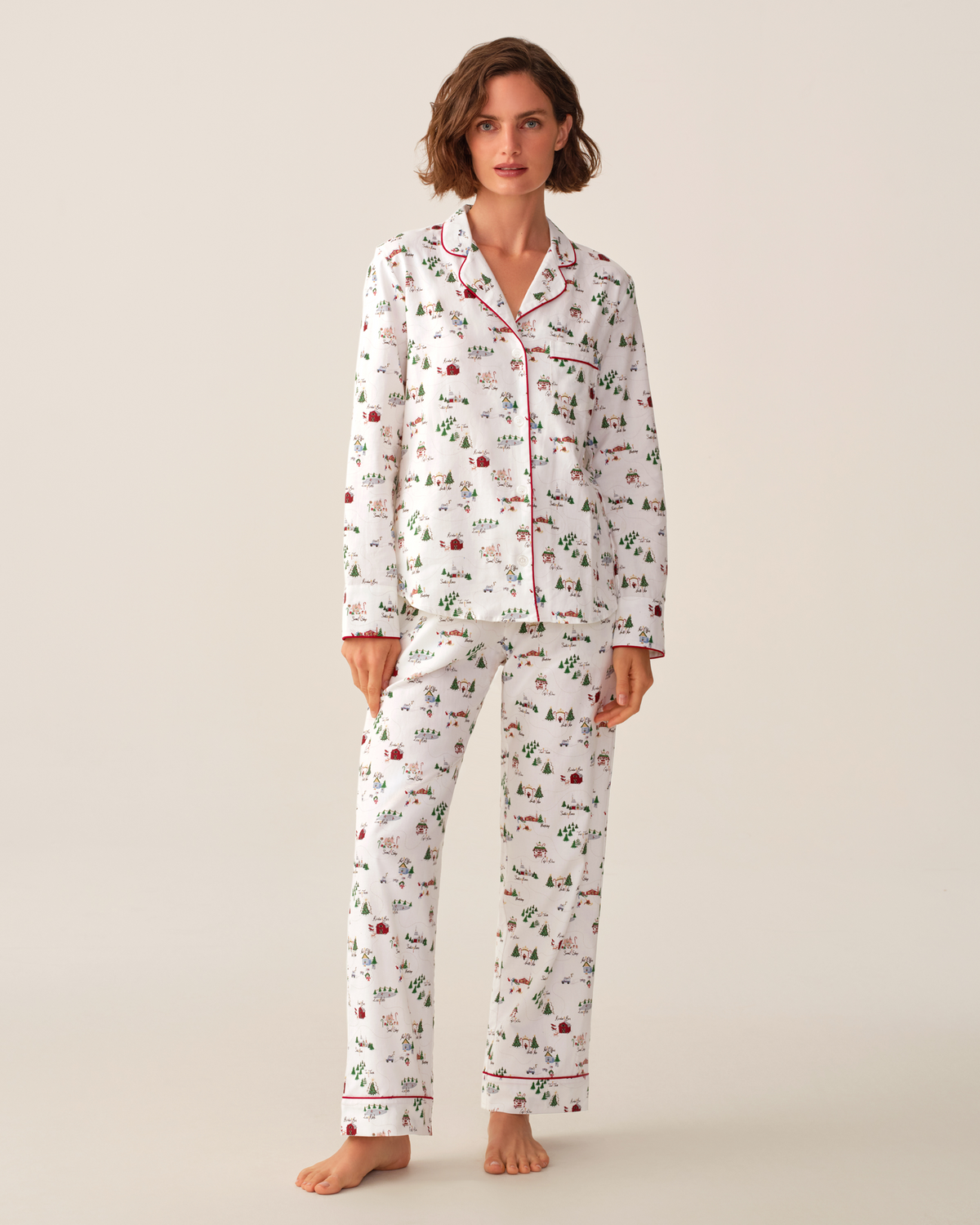 Women's twill pajama set in North Pole Chronicles by Petite Plume, featuring cozy fabric and festive holiday print.