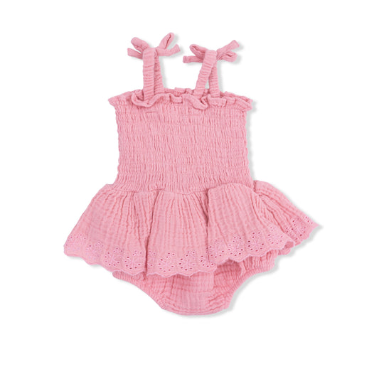 Angel Dear solid pink muslin smocked bubble with skirt, featuring a soft, breathable fabric and delicate smocking details.