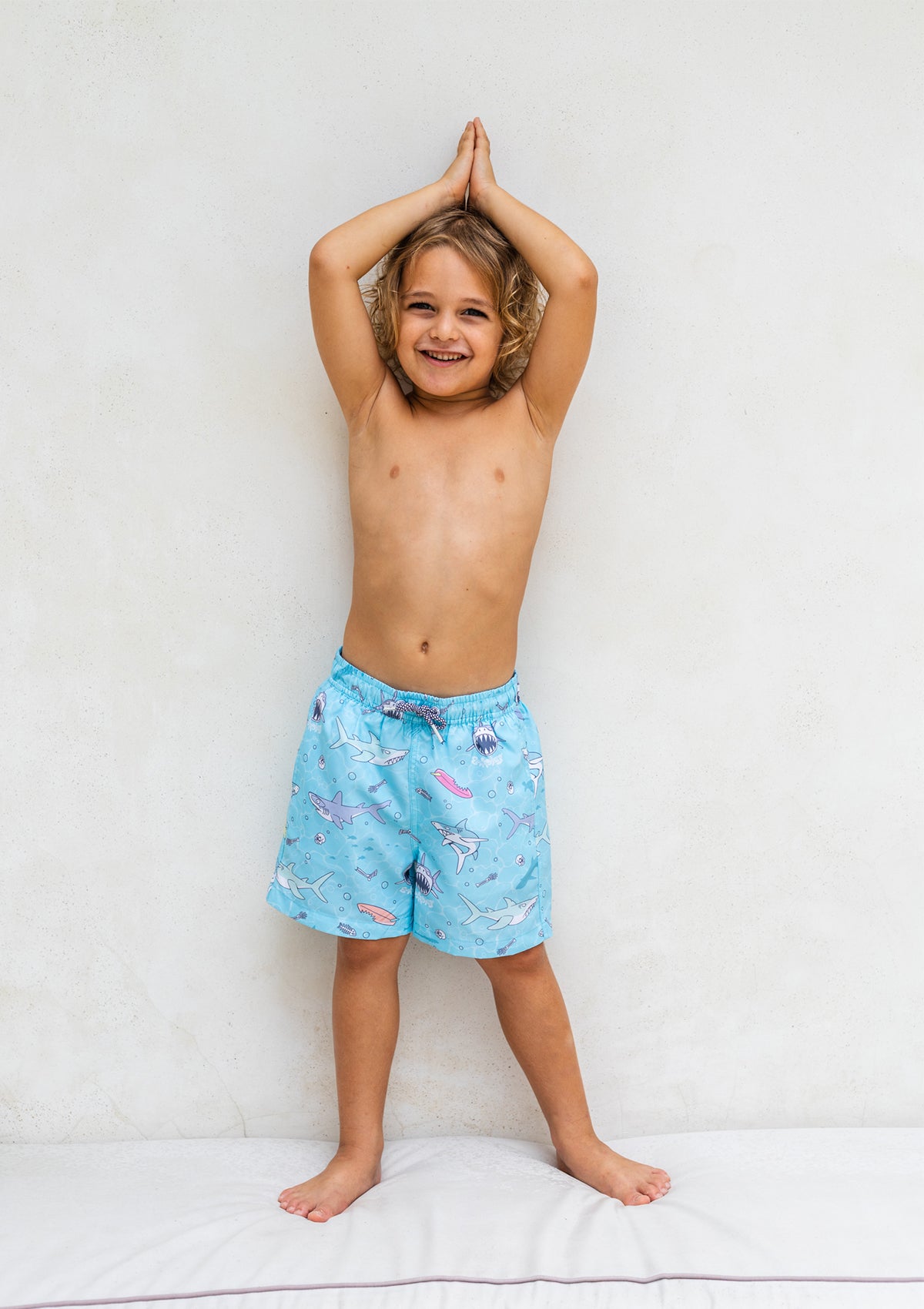 Kids' Boardies Sharky Waters swim shorts with shark print, designed for children, in vibrant colors suitable for beach or pool.