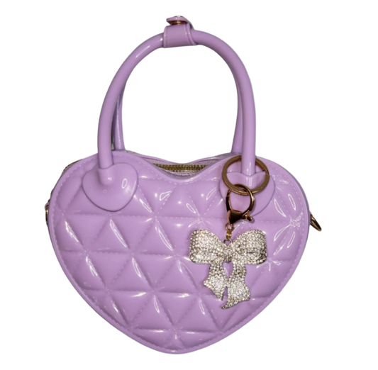 Lavender Kids Bella and Bow Quilted Jelly Heart Bag by Carrying Kind with heart-shaped design and quilted texture.