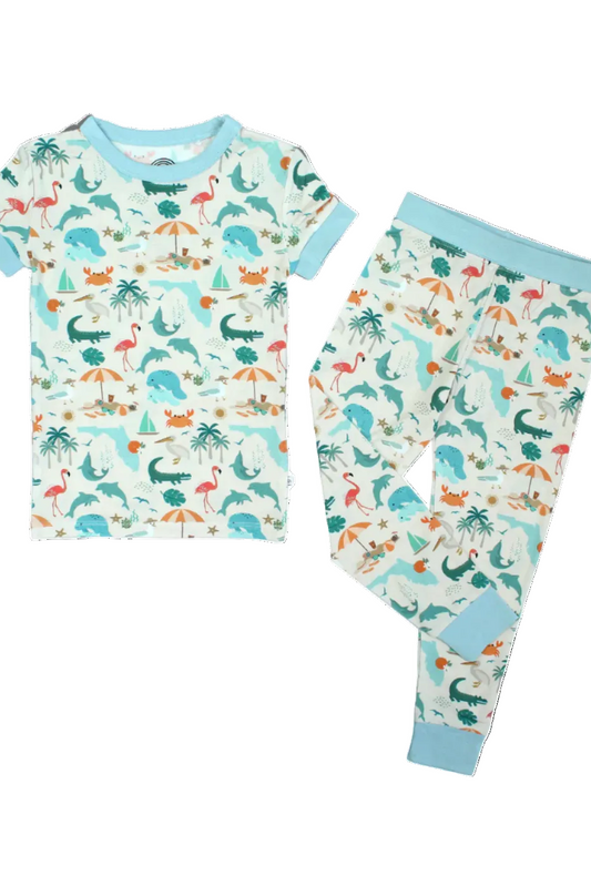 Toddler boy wearing Emerson and Friends Explore Florida souvenir bamboo pajamas set with colorful Florida map design.