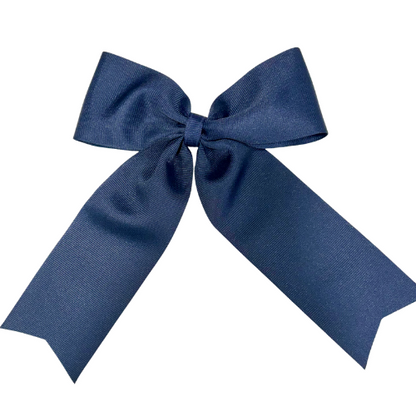 Large personalized embroidered bow with alligator clip by Flora Ottimer, featuring red fabric and custom embroidery details.