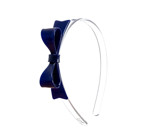 Large navy acrylic bow headband by Lilies and Roses NY, stylish accessory with a prominent bow detail.