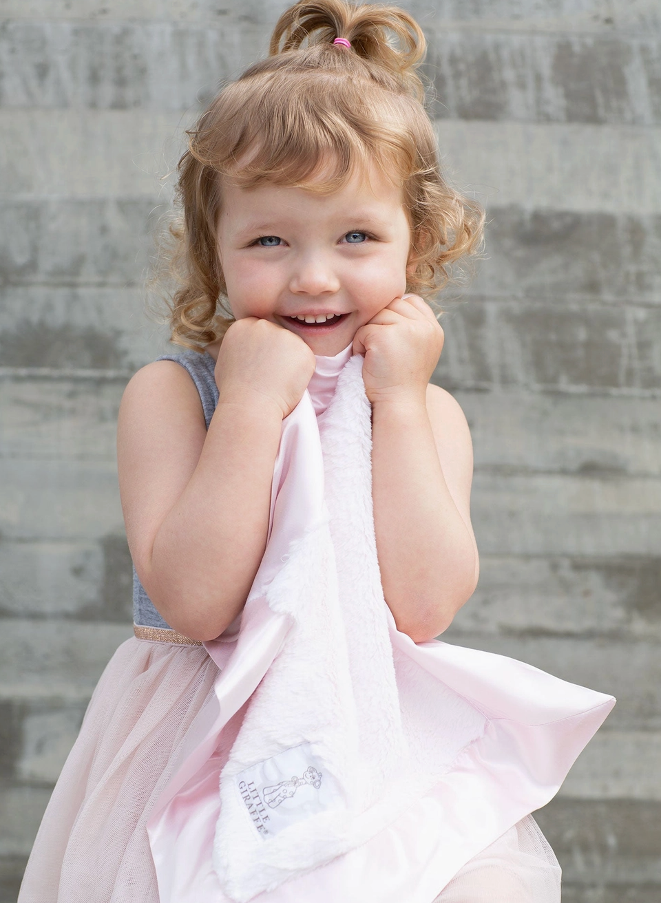 Little Giraffe Luxe Blanky in pink, soft plush baby blanket with a smooth, cozy texture and a gentle pink color.