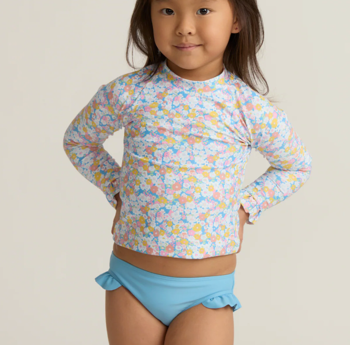 Girls Jasmine Blossom rashguard set by Minnow featuring a colorful floral design and long sleeves for sun protection.