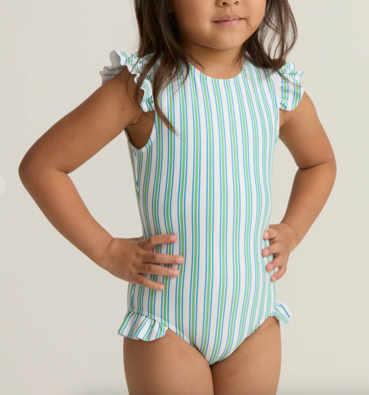 Girls Tamarin Stripe Ruffle Cap Sleeve Rashguard One Piece by Minnow, featuring colorful stripes and ruffle details on the cap sleeves.