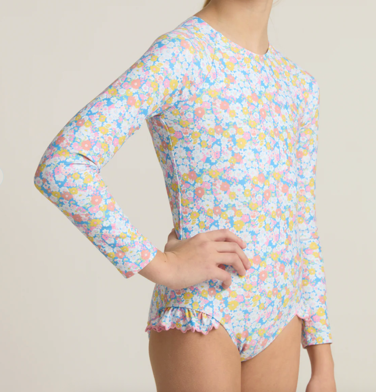 Girls Minnow Jasmine Blossom rashguard one-piece swimsuit with floral pattern, short sleeves, and comfortable fit.
