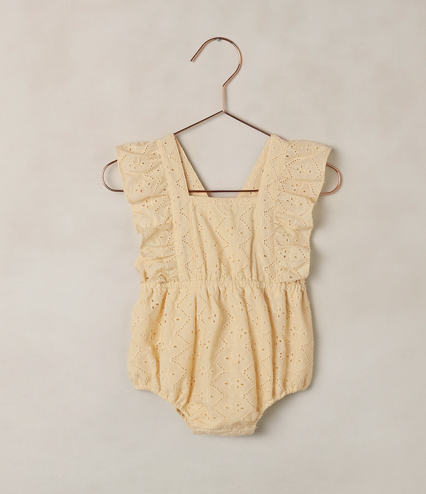Baby Lucy eyelet romper in lemon by Noralee, showing a cute, lightweight baby romper with eyelet fabric and short sleeves.