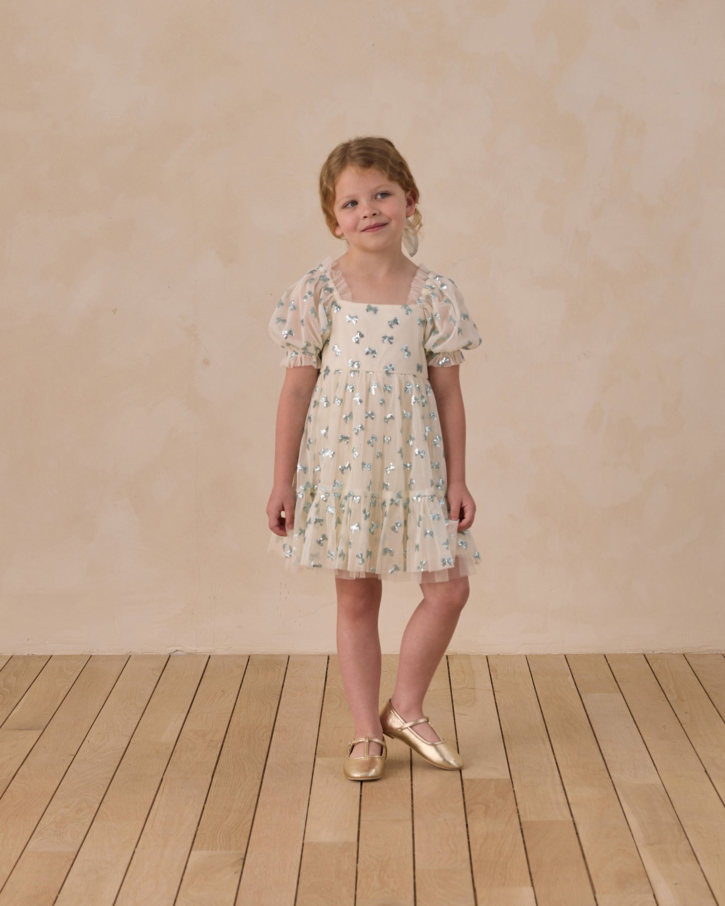 Noralee Louella dress with sequin bows, featuring elegant design and delicate embellishments, shown on a model.
