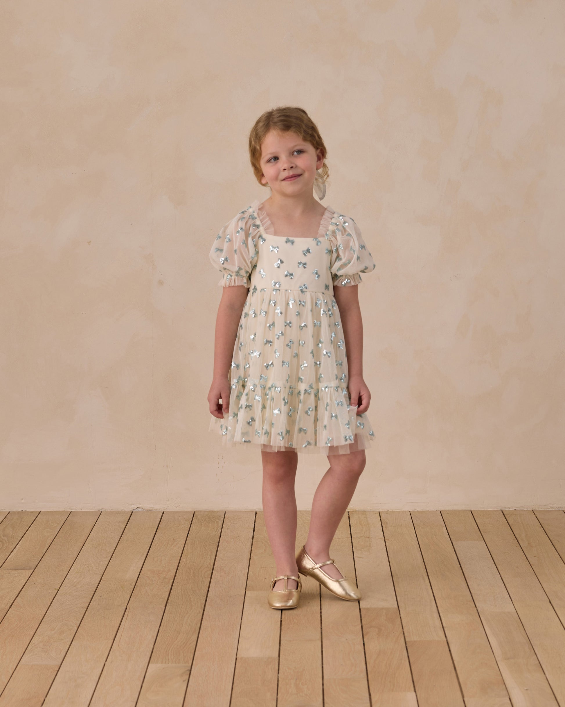 Noralee Louella dress with sequin bows, featuring elegant design and delicate embellishments, shown on a model.