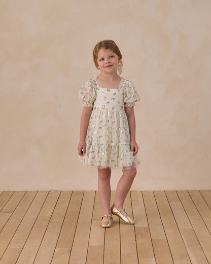 Noralee Louella dress with sequin bows, featuring elegant design and delicate embellishments, shown on a model.
