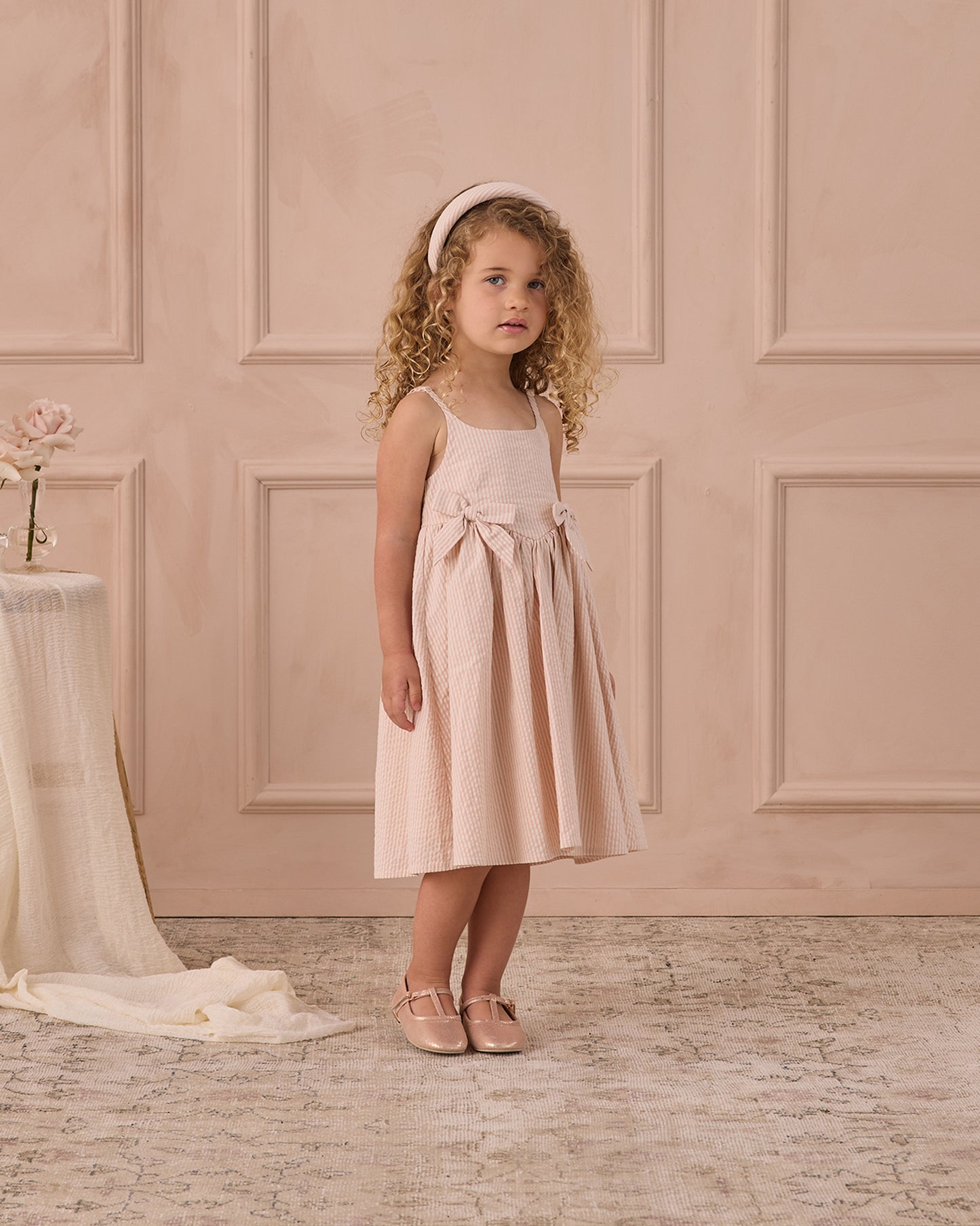 Girls Beatrice Midi Dress in Petal Pink by Noralee, showing a stylish, flowy pink dress with floral details on a young girl.