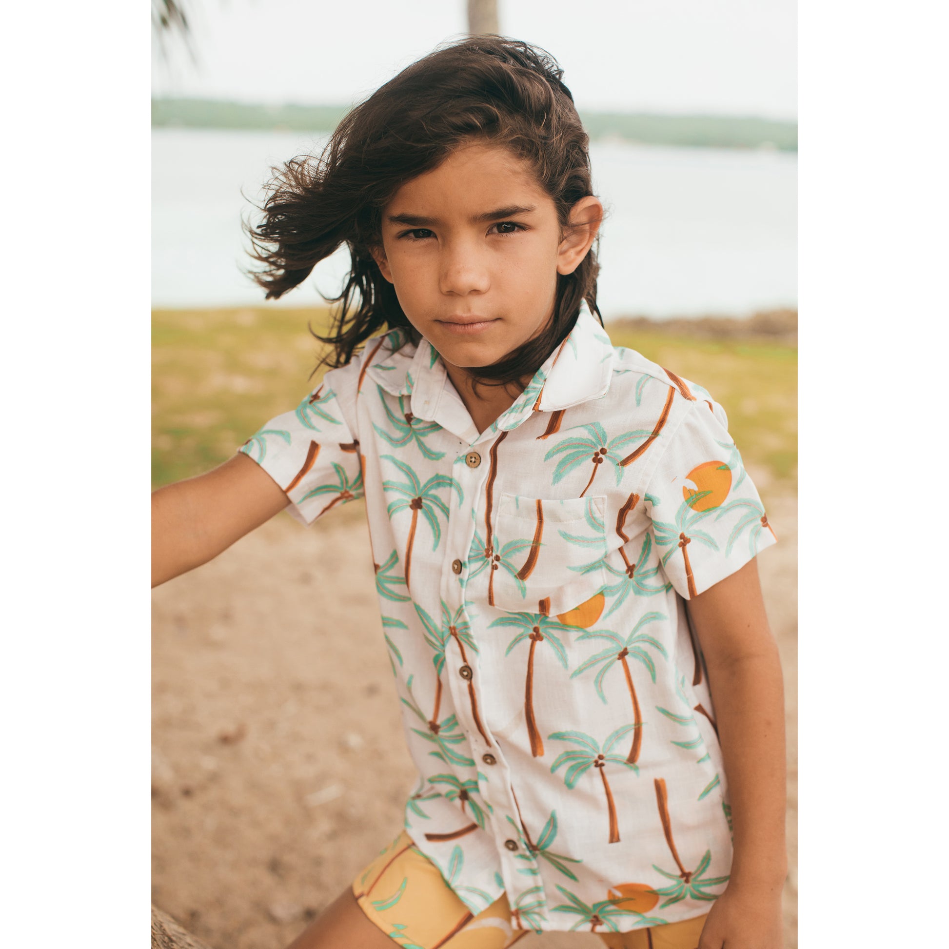Pepita & Me boys' Palmeras Guaybera button-down shirt with green palm leaf pattern, short sleeves, and collar.