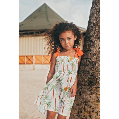 Pepita & Me Palmeras smocked dress for girls with ruffled sleeves and colorful palm leaf print on lightweight fabric.
