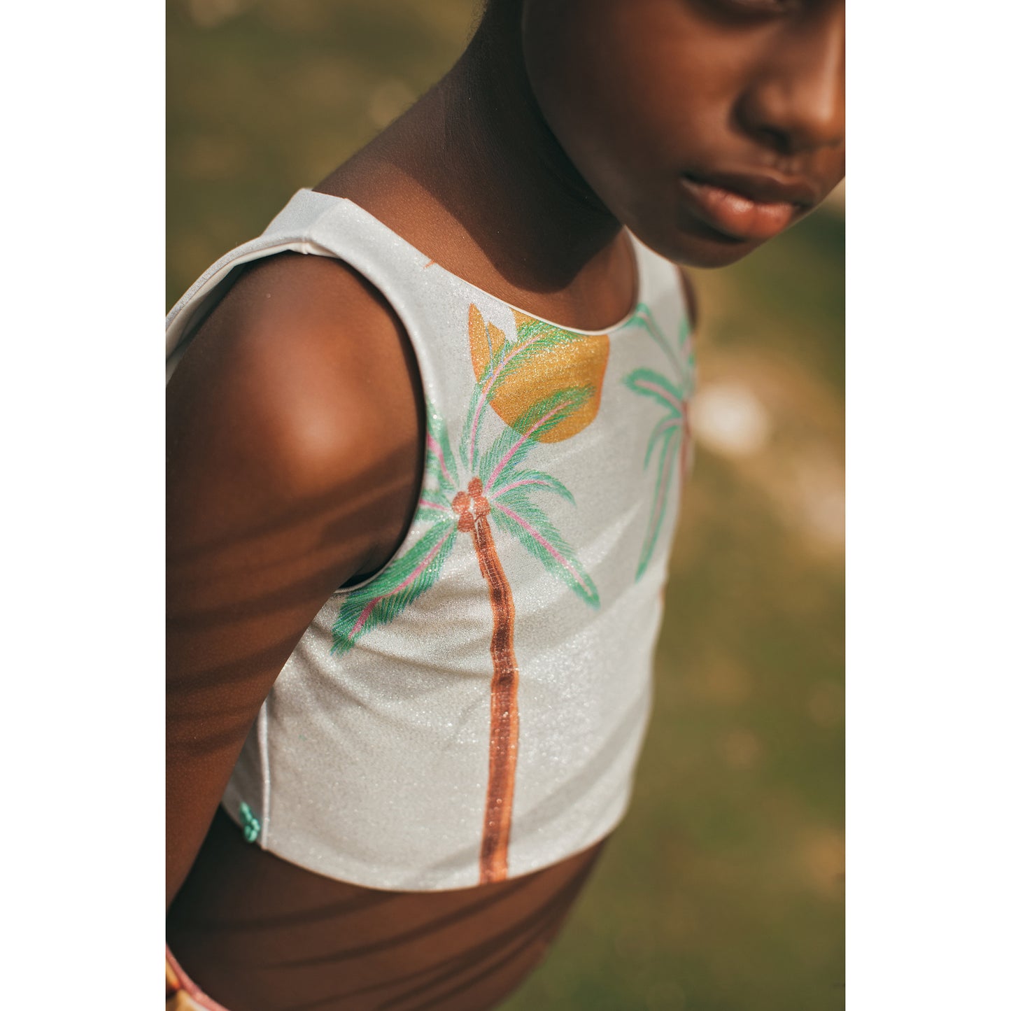 South End Pool Bikini by Pepita & Me featuring a vibrant floral pattern and adjustable straps on a model.