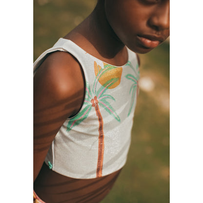 South End Pool Bikini by Pepita & Me featuring a vibrant floral pattern and adjustable straps on a model.