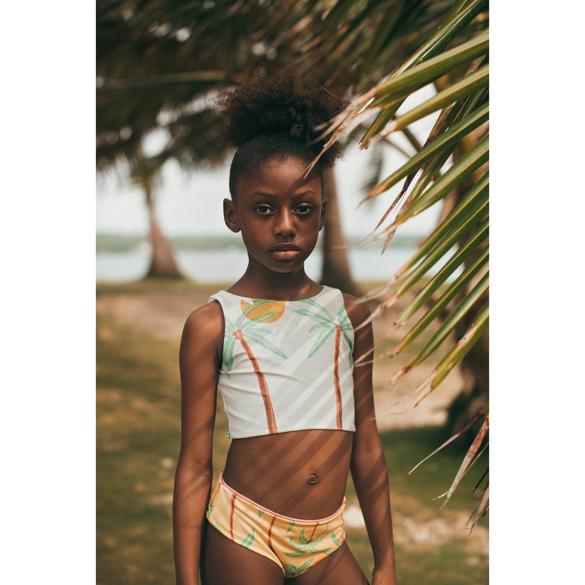 South End Pool Bikini by Pepita & Me featuring a vibrant patterned bikini top and matching bottom on a model.