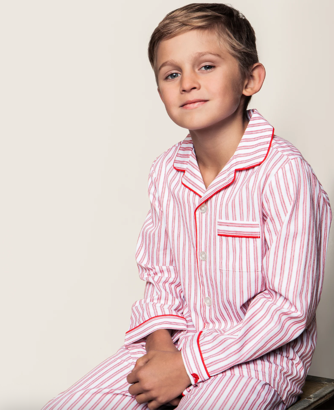 Kids antique red ticking pajama set by Petite Plume, featuring a cozy long-sleeve top and matching pants with classic ticking pattern.
