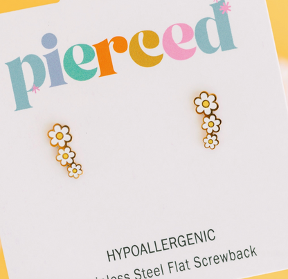 Child wearing Daisy Crawler hypoallergenic earrings from Pierced Co, featuring cute floral design for kids' sensitive ears.