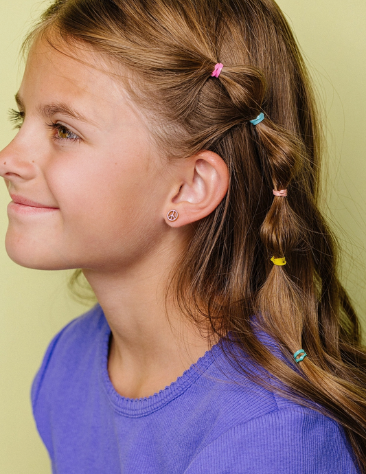 Pierced Co peace sign flat screw back hypoallergenic earrings shown in a close-up image, featuring a minimalist silver design.