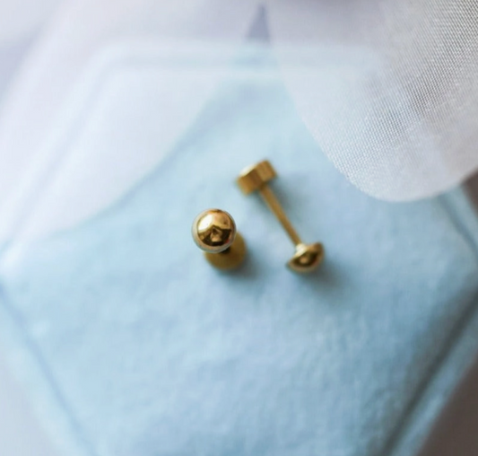 Tiny gold ball screw back earrings by Pierced Co, showcasing small, shiny gold studs with screw back closure.