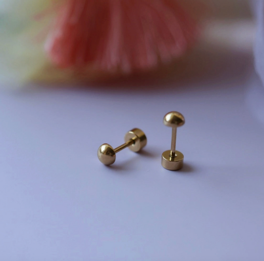 Tiny gold ball screw back earrings from Pierced Co, featuring small spherical gold studs with secure screw back closures.