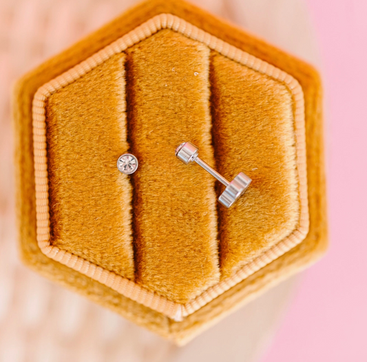 Tiny silver diamond earrings with screw back, crafted by Pierced Co, featuring sparkling gemstones and secure fastening.