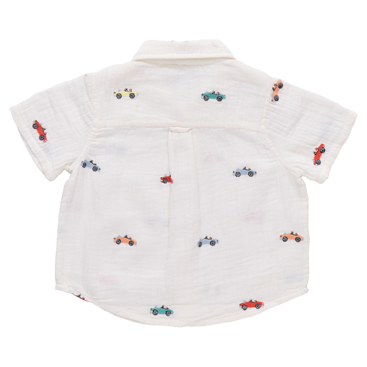 Boy wearing Pink Chicken button-down Jack shirt with vintage car embroidery, showcasing casual style for kids.