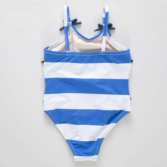 Girls Lottie Bow Suit by Pink Chicken with wide blue stripes, featuring a cute bow detail on the front of the sleeveless dress.