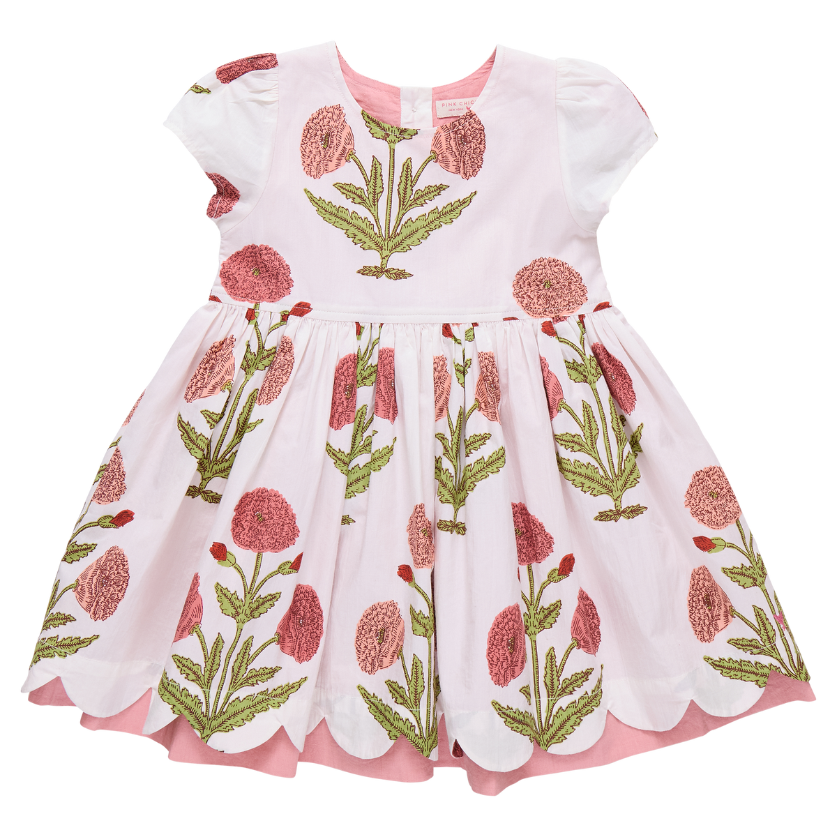 Girl wearing Pink Chicken Marisol Dress in Rose Dandelion with floral pattern, featuring ruffles and soft fabric.