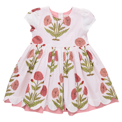 Girl wearing Pink Chicken Marisol Dress in Rose Dandelion with floral pattern, featuring ruffles and soft fabric.