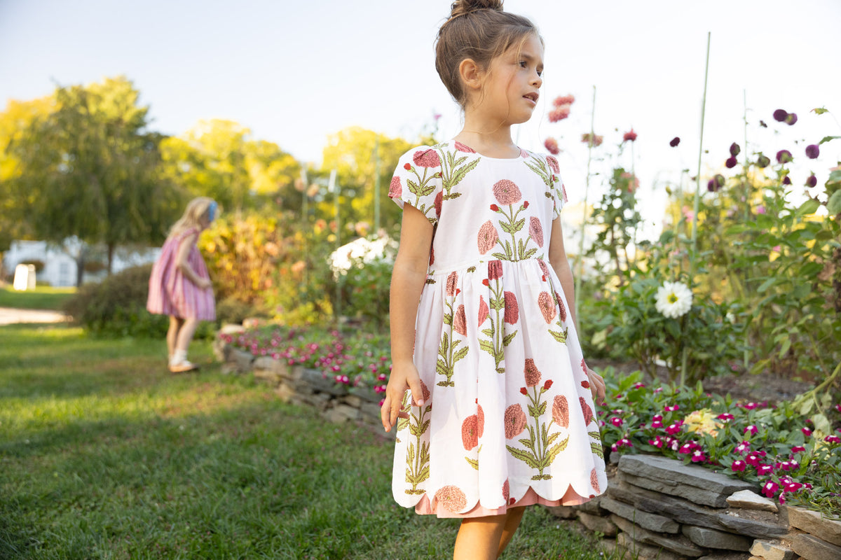 Girls Marisol Dress by Pink Chicken in Rose Dandelion fabric, featuring a pink and floral dress with ruffle details for girls.