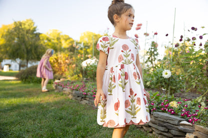 Girls Marisol Dress by Pink Chicken in Rose Dandelion fabric, featuring a pink and floral dress with ruffle details for girls.